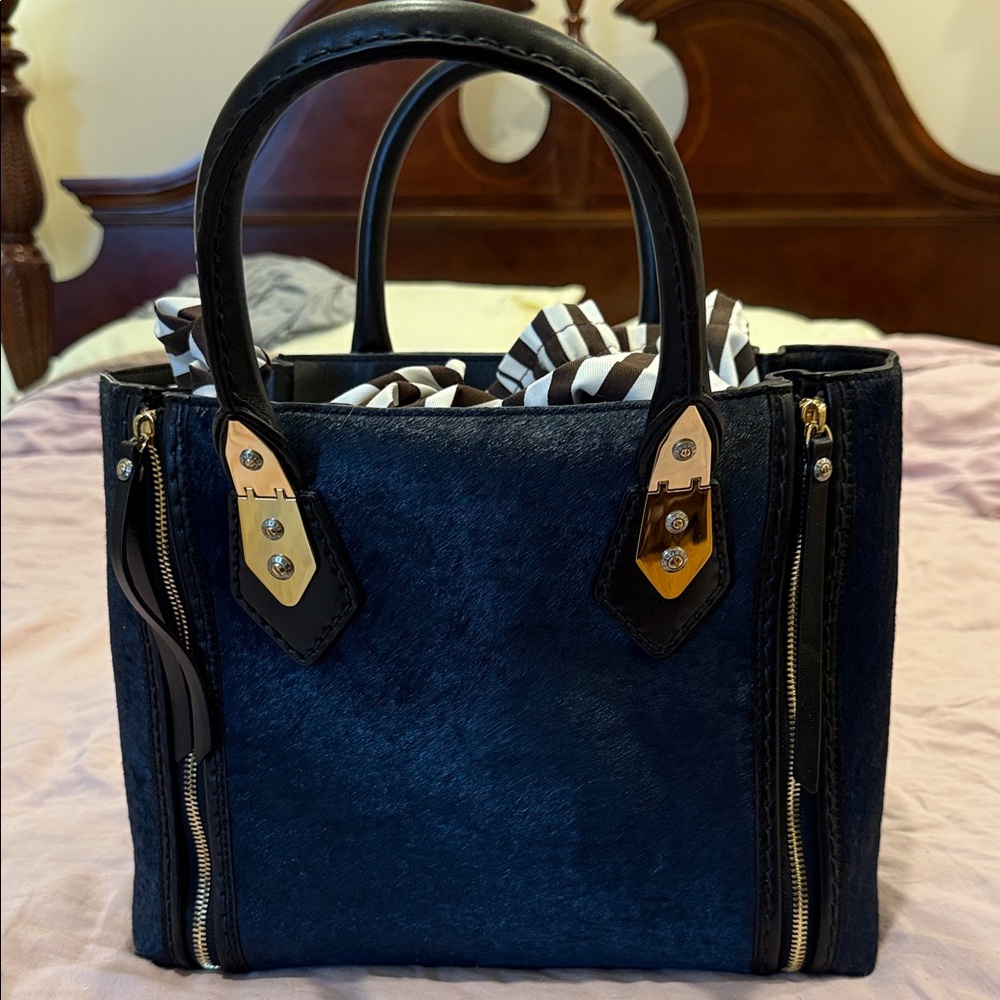 The iconic Henri Bendel Elegant Black and Gold blue calf hair Women's Handbag